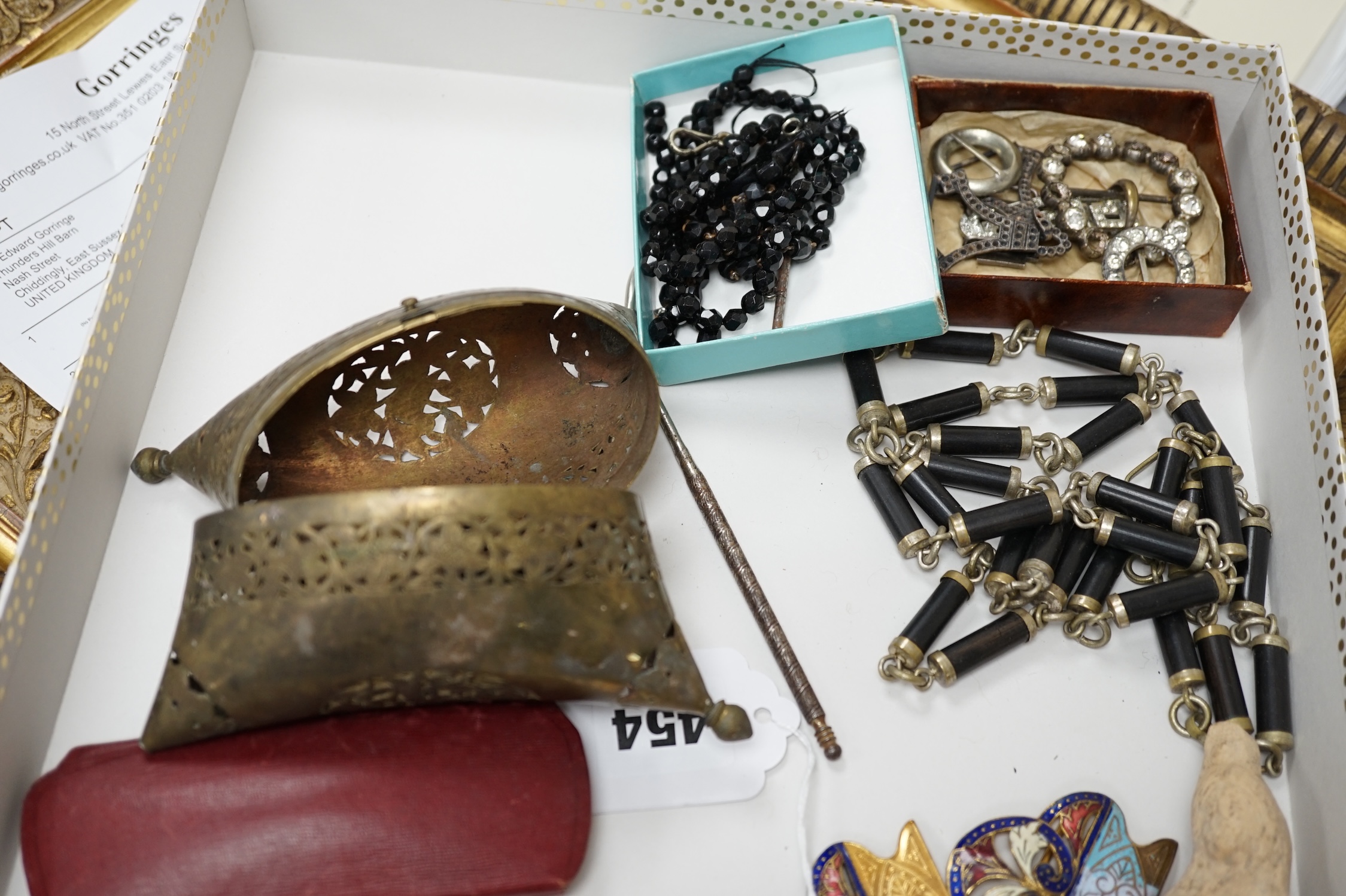 Mixed collectibles to include enamel belt buckles, a silver cased amber and gold mounted cigarette holder, Japanese lacquered case, fans etc